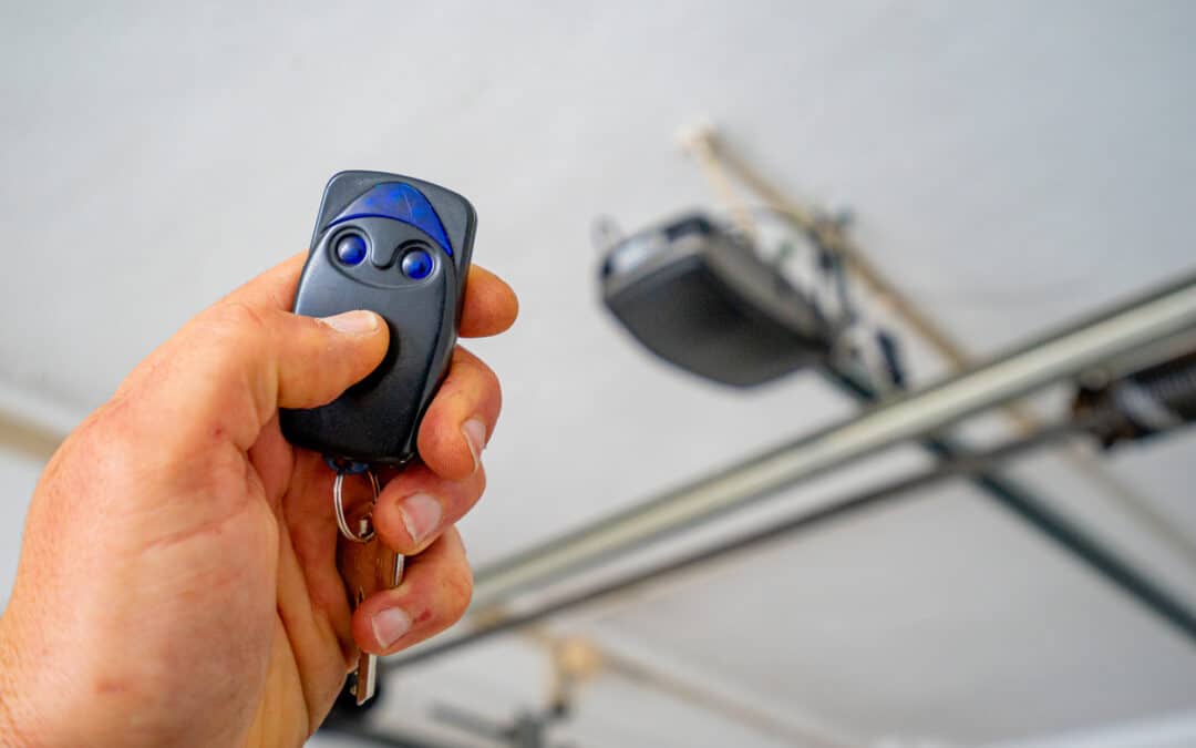 White person's hand holding garage door opener