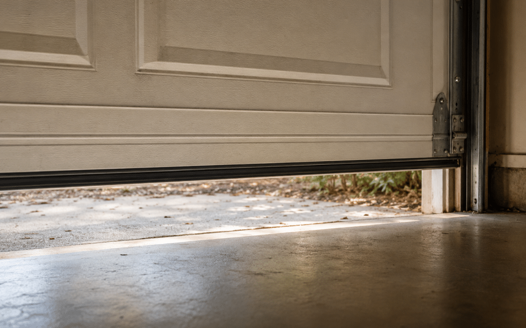 Visible gap under garage door caused by an uneven seal or floor